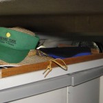 edge on cupboard for hats